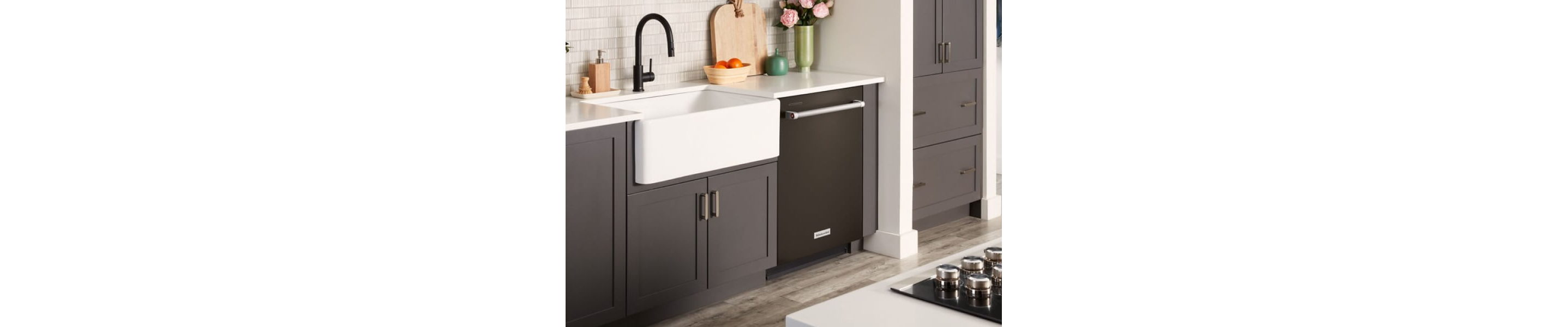 Flush dishwasher installed next to a farmhouse sink