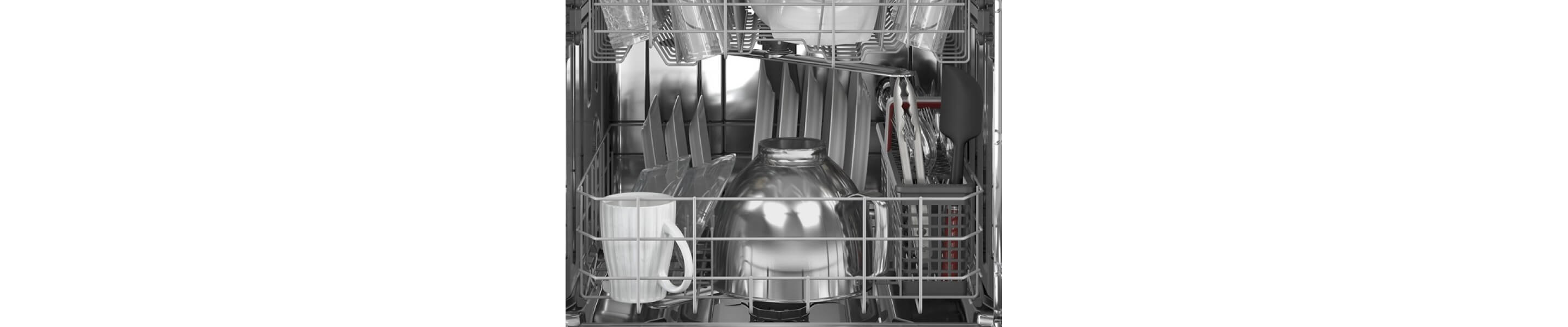 Clean white plates, cups and mixing bowls inside a dishwasher