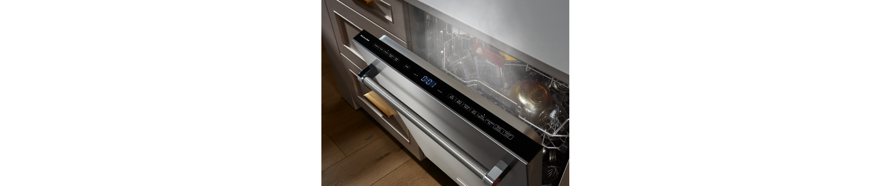 An opened KitchenAid® dishwasher letting the items inside dry