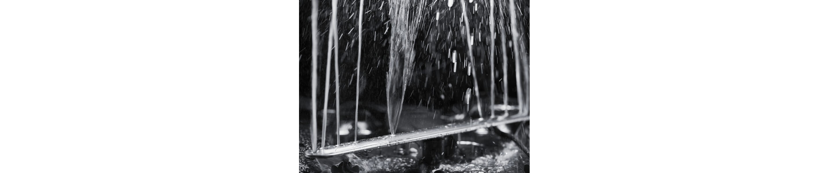 A dishwasher spray arm spewing water