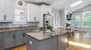 Stainless steel appliances in a bright kitchen with white cabinetry