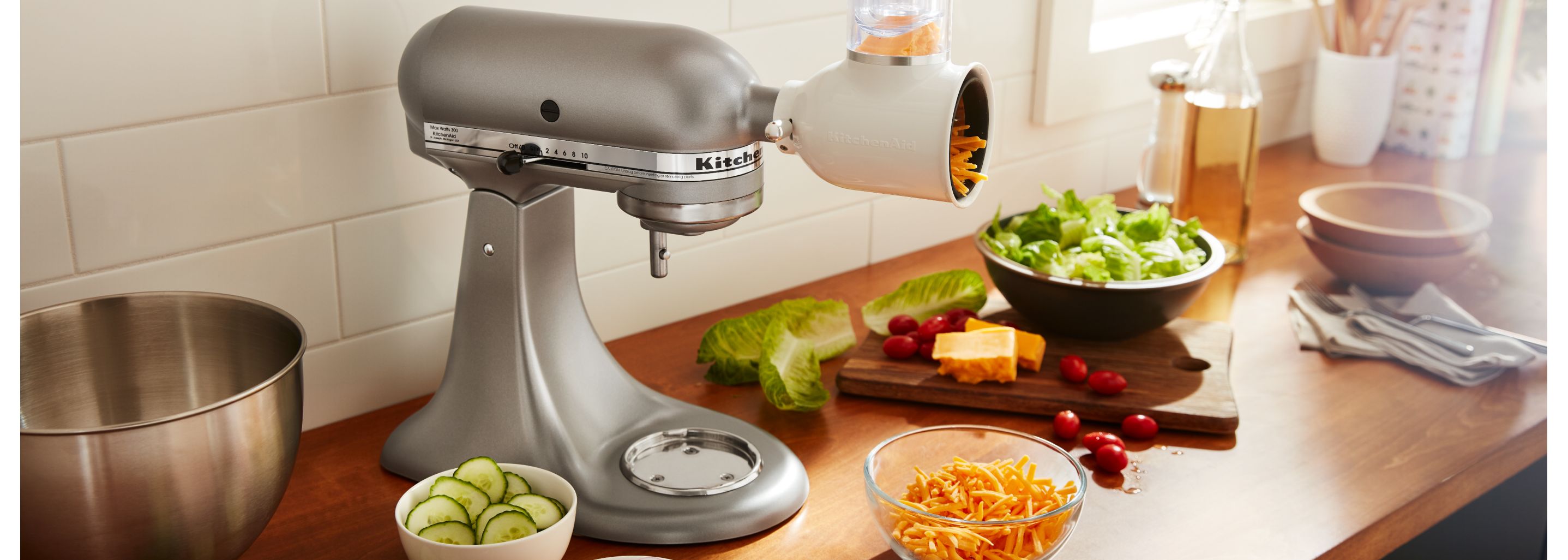 Silver KitchenAid® stand mixer with Fresh Prep Slicer/Shredder Attachment