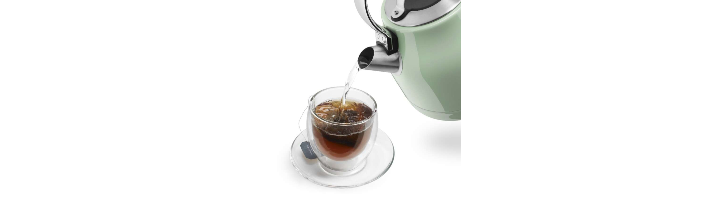 Water pouring from an electric kettle into a mug of tea