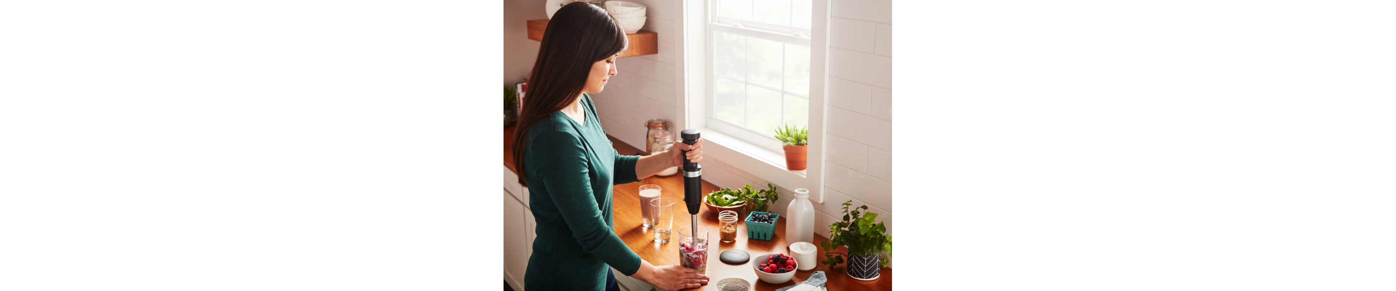 Person blending berry smoothie withKitchenAid® hand blender 