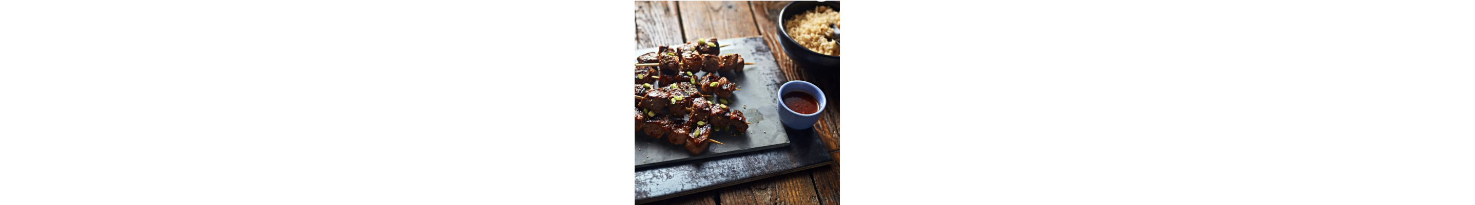 Meat with hot sauce on a cutting board