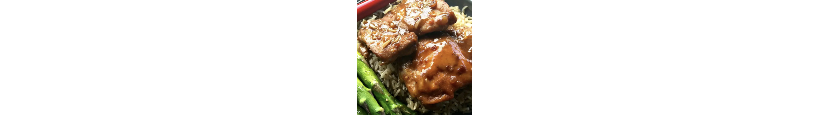 A plate of baked chai teriyaki chicken thighs over rice