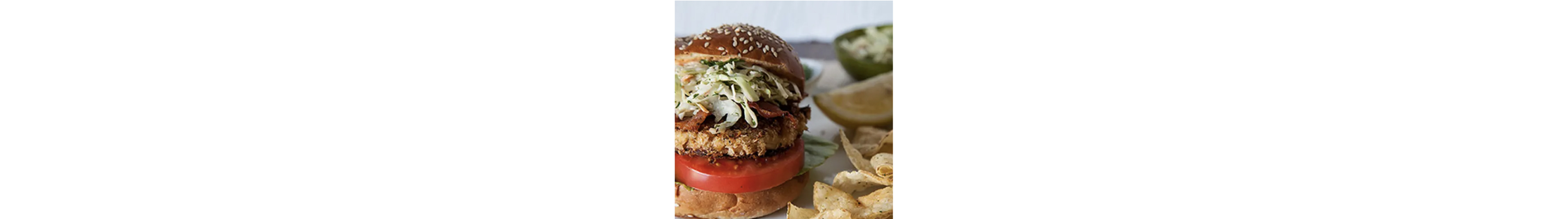 A king crab BLT sandwich with potato chips