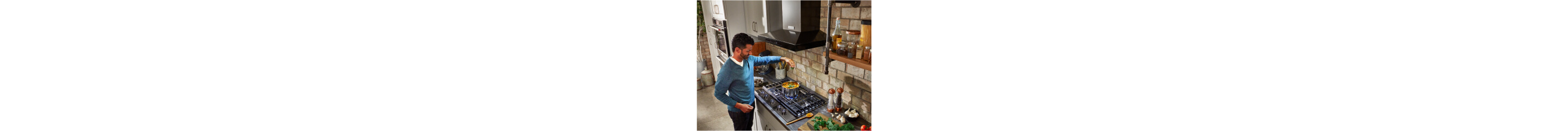 A person using their cooktop in a kitchen