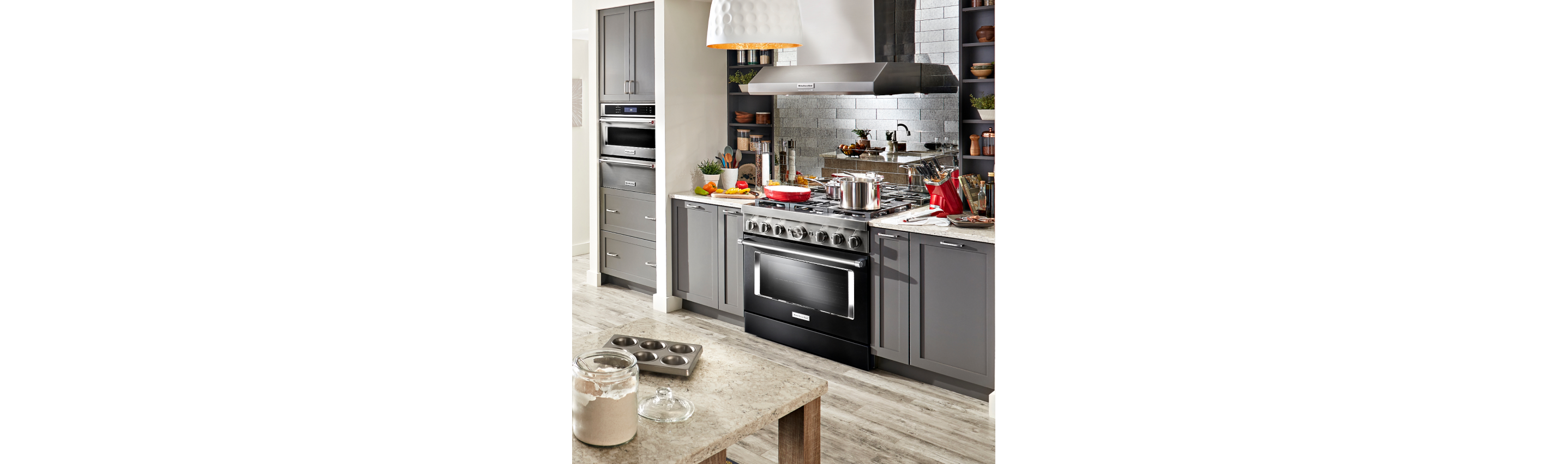 A wall of KitchenAid® appliances installed into a sleek, modern kitchen.