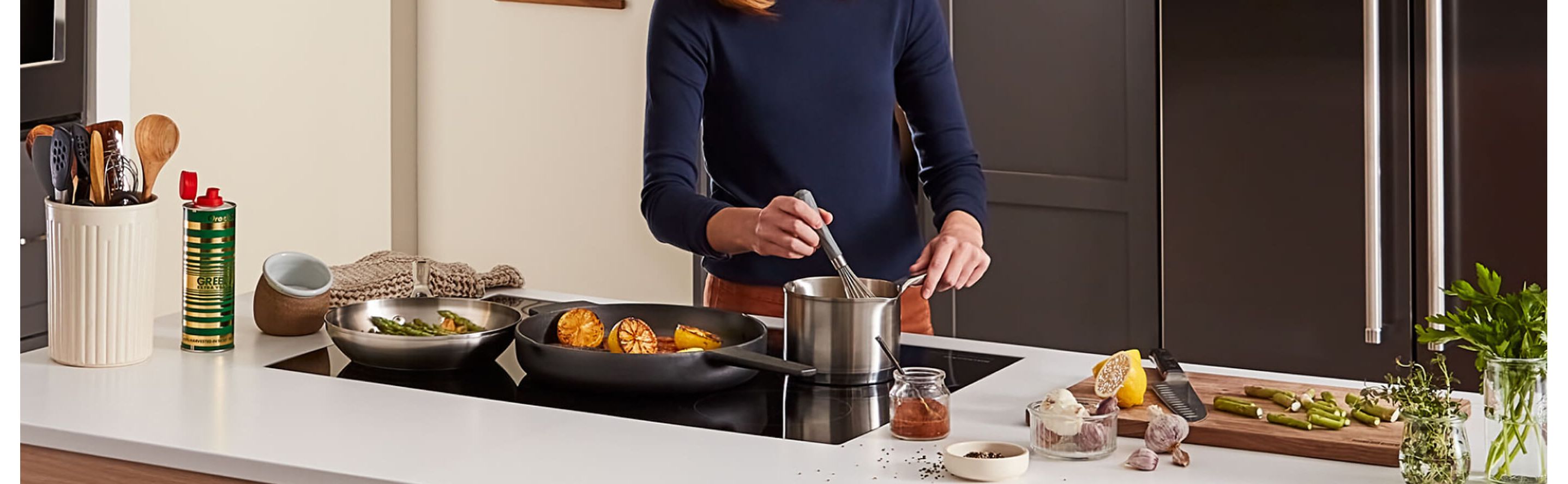 Person stirring food in sauce pan on an induction stovetop