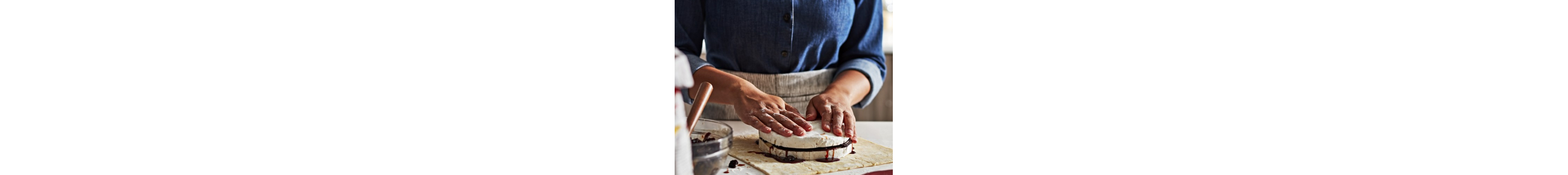 Person making a pastry on a countertop