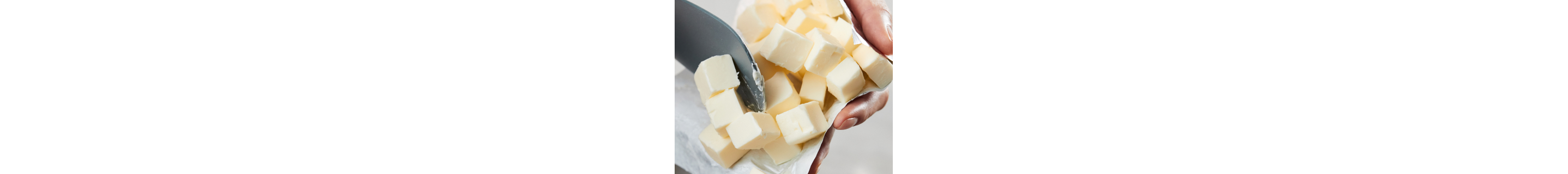 A person holding squares of butter and a rubber spatula 