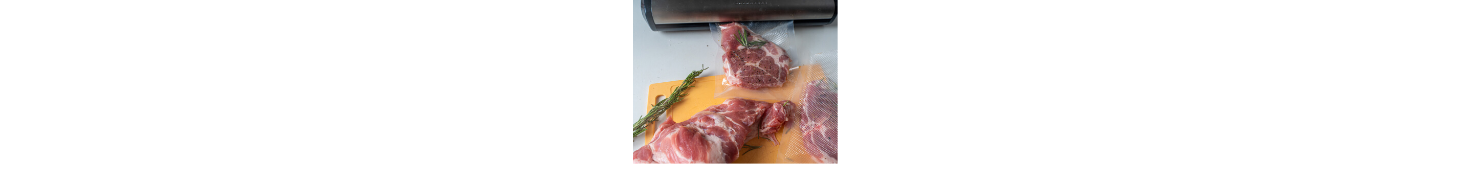 Meat seasoned with rosemary, two of the pieces are in sous vide bags