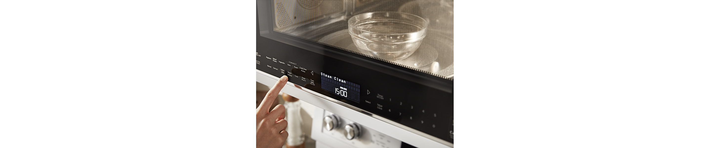 Person selecting a cook option on a KitchenAid® microwave