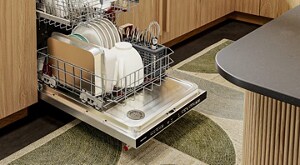 An open dishwasher loaded with clean dishes