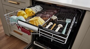 The top rack of a dishwasher shown with dishes and silverware in it