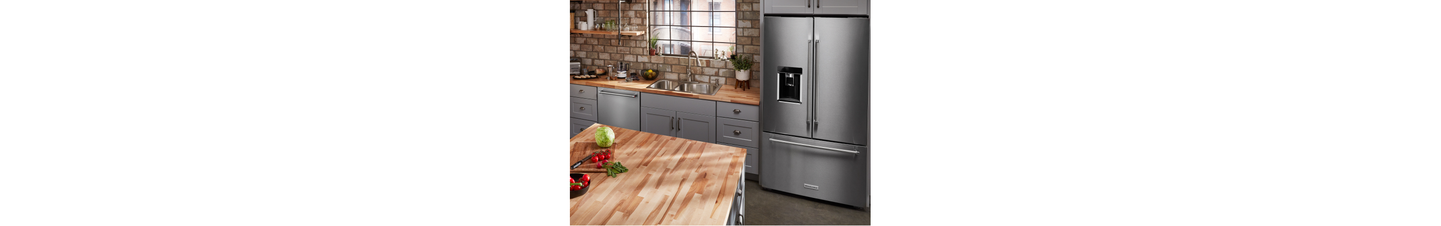 Stainless steel, KitchenAid® French-door refrigerator in gray cabinetry