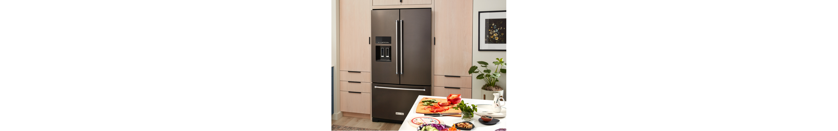 KitchenAid® French-door refrigerator built into light brown cabinetry