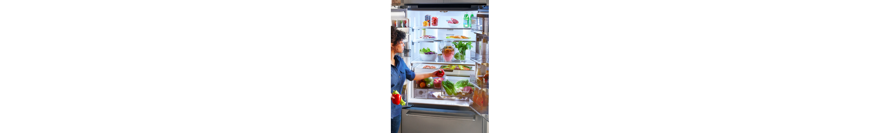 Person placing produce inside a French door refrigerator
