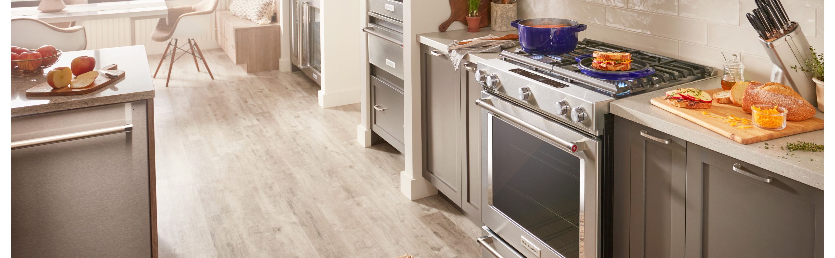 A KitchenAid® gas stove in the middle of a kitchen