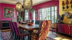 A rich jewel-toned dining room with magenta and yellow design elements.