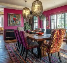 A rich jewel-toned dining room with magenta and yellow design elements.