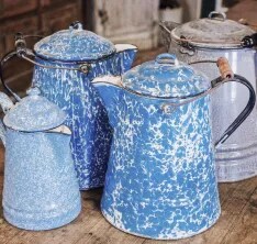 A group of aluminum kettles in a mottled blue finish
