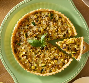 A person taking a slice of a quiche.