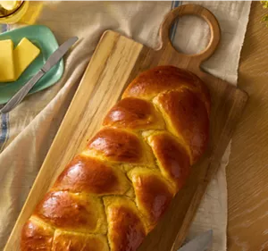 A loaf of braided brioche bread.