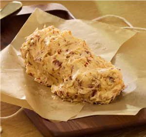 Freshly made compound butter on parchment paper.