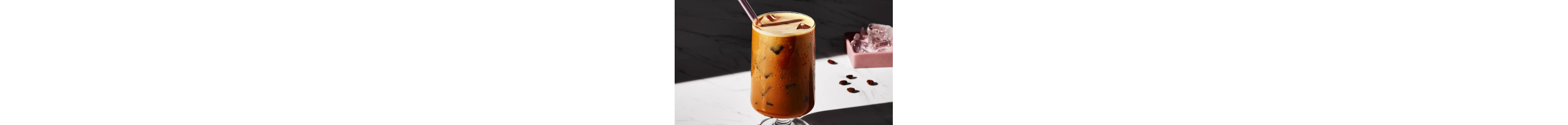 Iced espresso in a glass with a straw