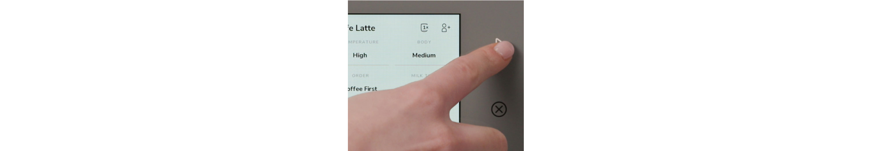 Person selecting settings on their espresso machine's screen