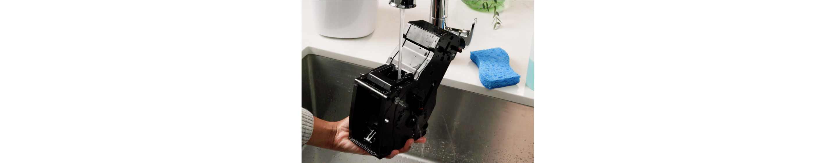 Espresso machine brew unit being cleaned