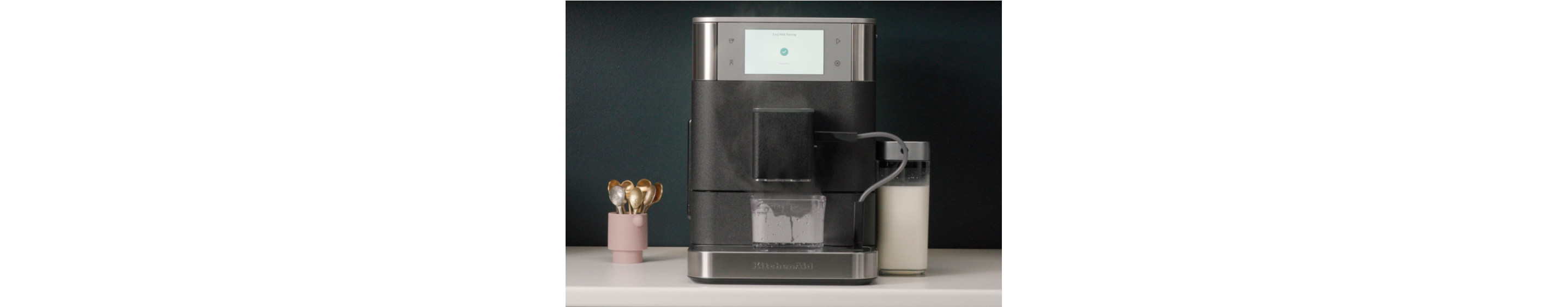 Espresso machine frother being cleaned automatically
