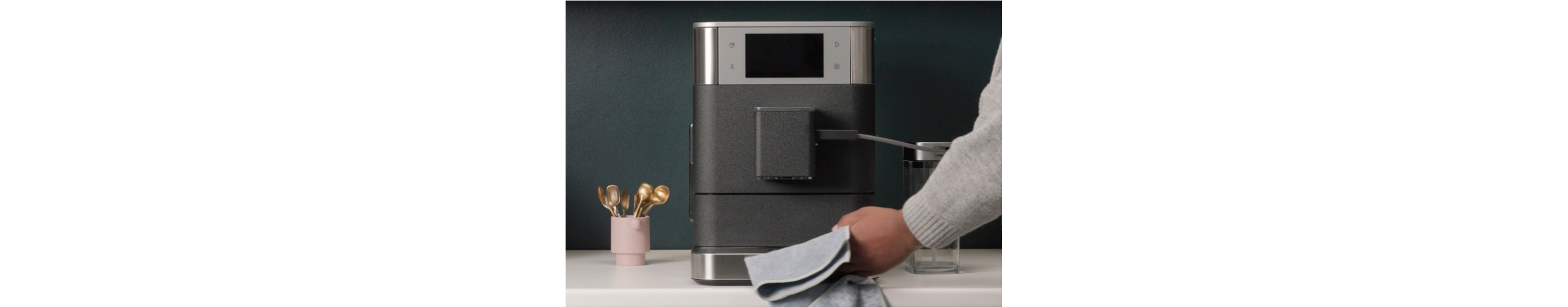 Person wiping an espresso machine