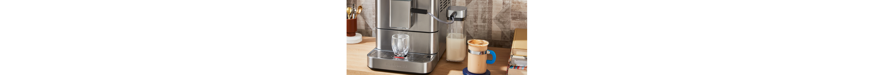 Woman steaming milk with an espresso machine.