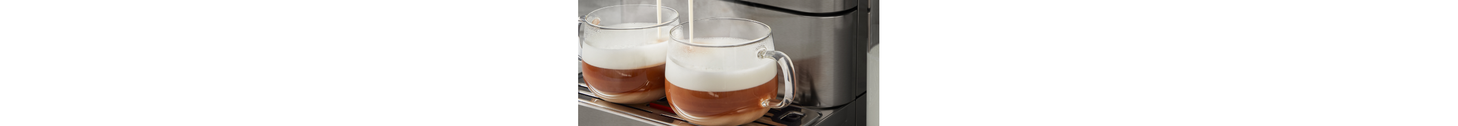 Two cups of espresso on an espresso machine drip tray