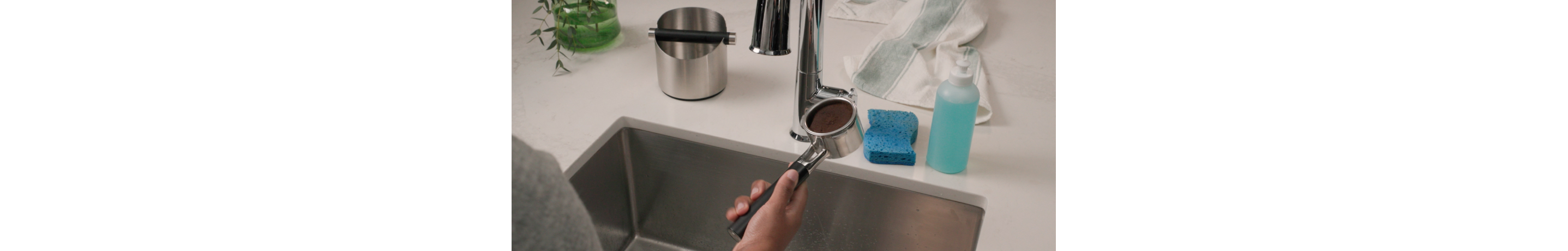 Person cleaning the espresso portafilter basket