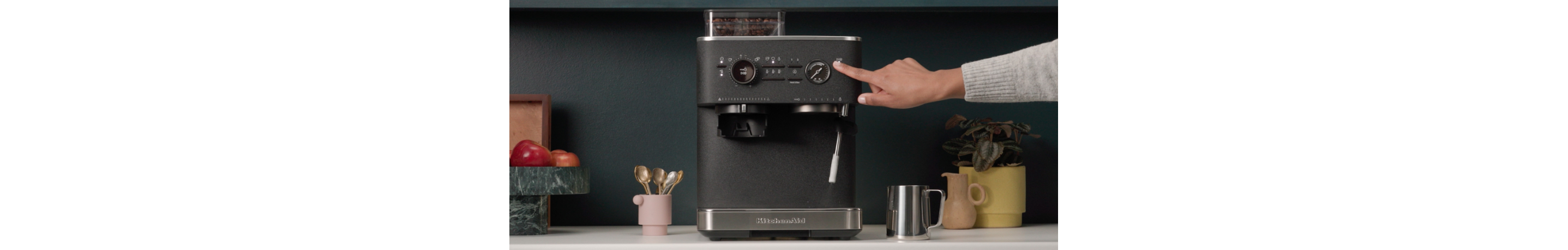 Person using an espresso machine steam wand