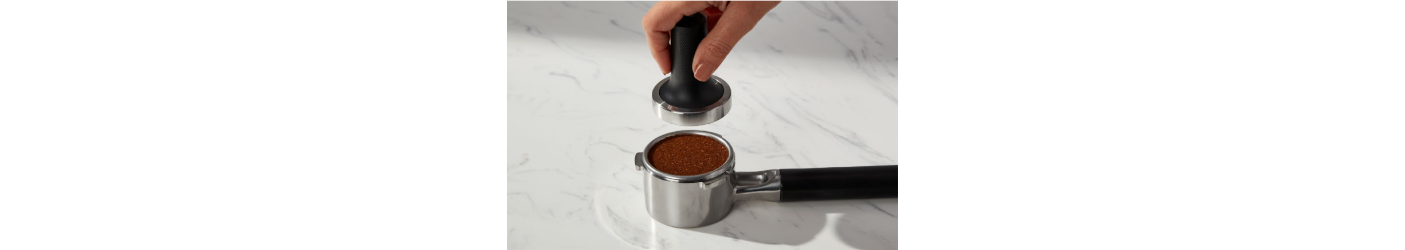 Tamped coffee grounds inside of a portafilter