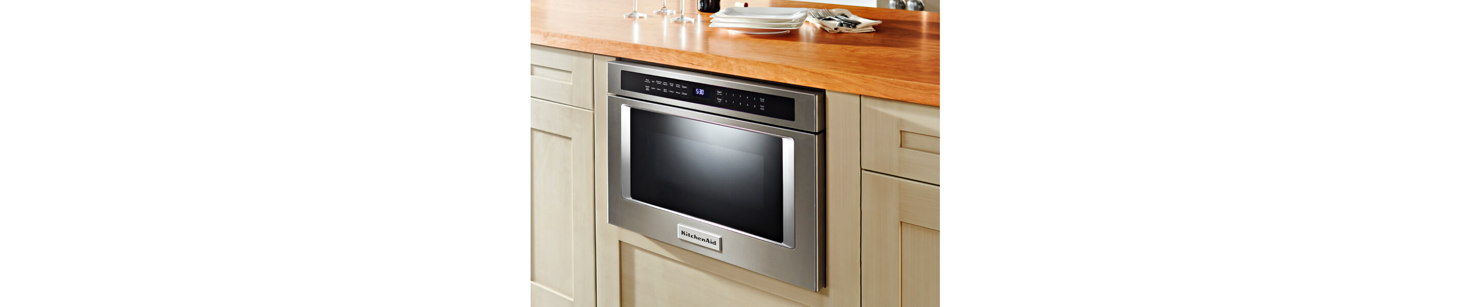 Built-in KitchenAid® microwave beneath wood block countertop