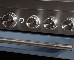 A closeup of the knobs on a range