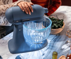 A KitchenAid® stand mixer with a glowing glass bowl