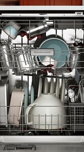 An open dishwasher with dishes inside.