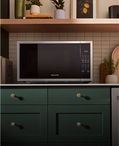 A stainless steel KitchenAid® microwave on a countertop.