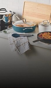 Dishes on a counter surrounded by teal cookware.
