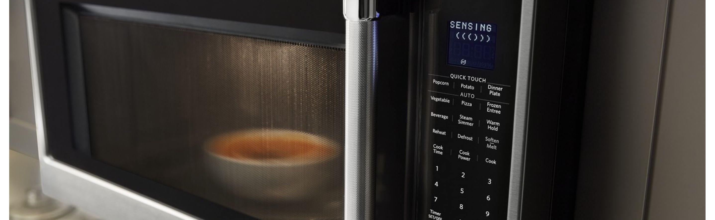 Food cooking in the microwave with SENSING shown on the display