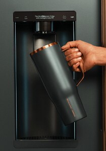 A person filling their Corkcicle bottle