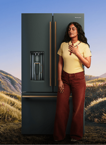 Radhi Devlukia taking deep breaths in front of The MindFULLness Fridge
