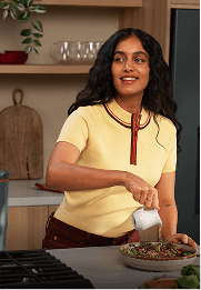 Radhi Devlukia preparing a dish in a kitchen
